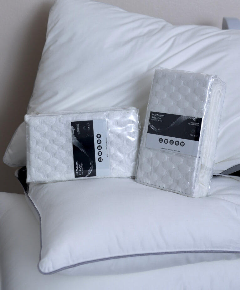 premium pillow protector with breathable, moisture-wicking cotton surface, shields against sweat, spills, and allergens.